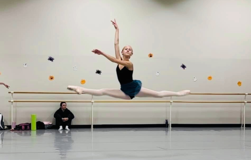 ballet student leaping in a dance class